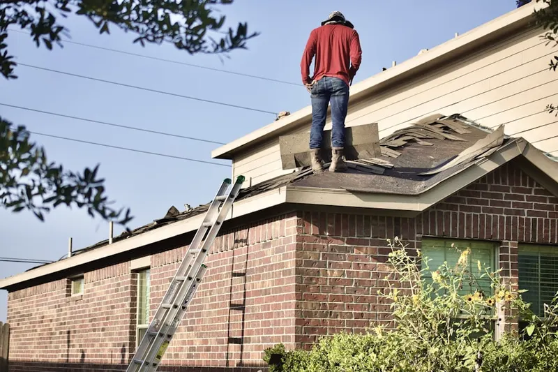Professional roofer working on a residential roof in Martha Lake